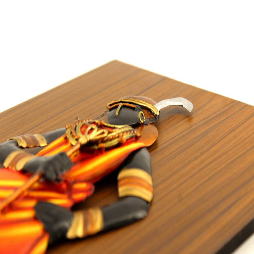 Close up view of handcrafted Bastar iron craft tribal woman wall art highlighting facial form, jewelry, and textile detailing