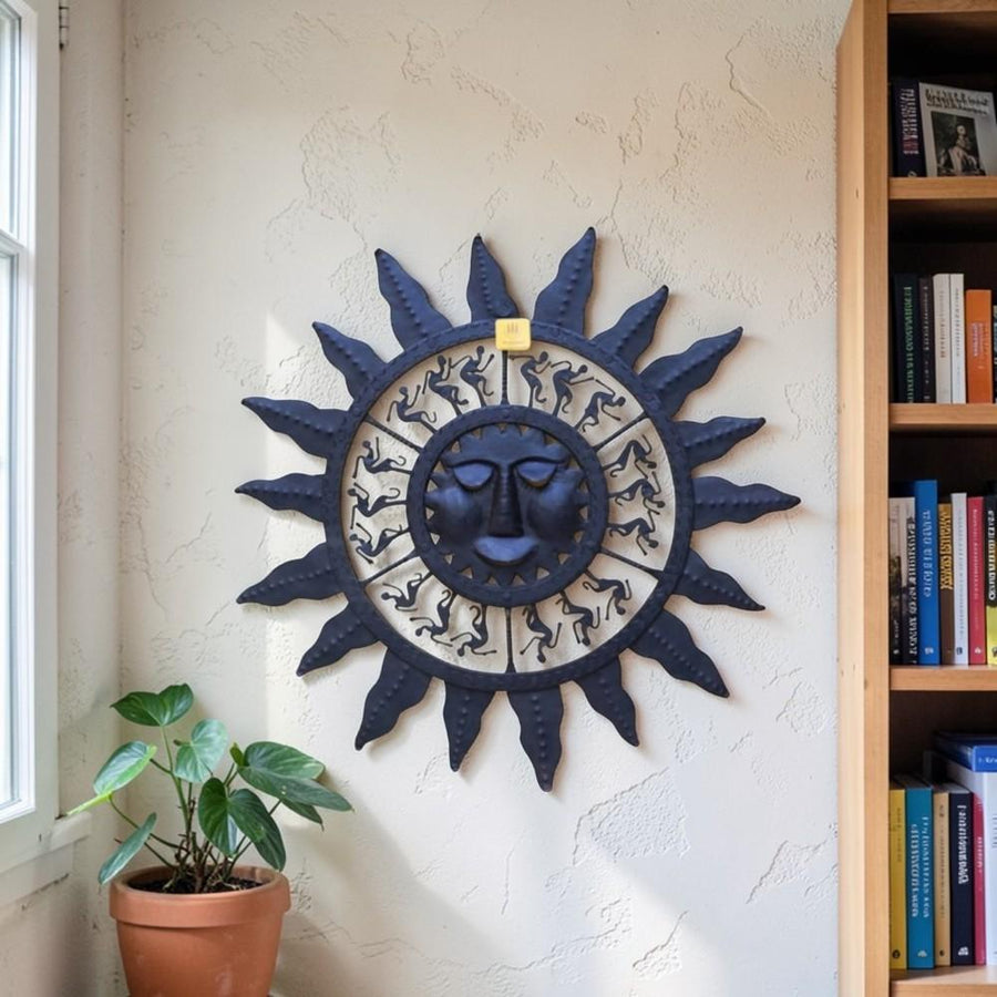Handmade Bastar iron sun mask wall hanging in black displayed on wall, symbolizing energy and positive vibes for home decor