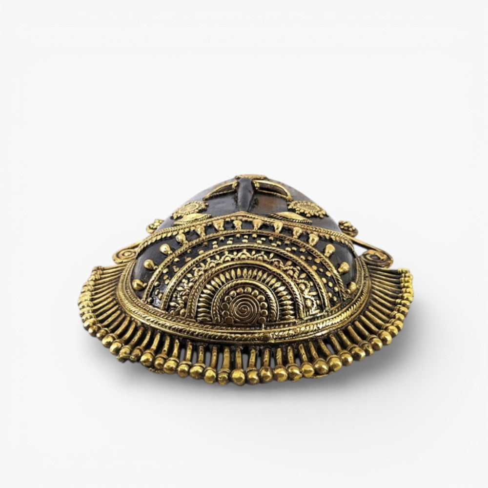 Bottom angled view of handcrafted Bastar art brass mask highlighting ornate headgear detailing and traditional Dhokra metal craftsmanship