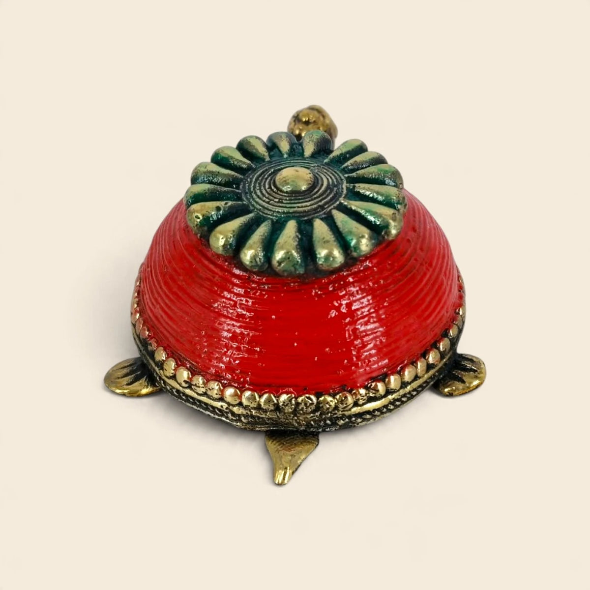 Rear view of handcrafted brass turtle trinket box showing red coiled shell, floral lid and brass legs