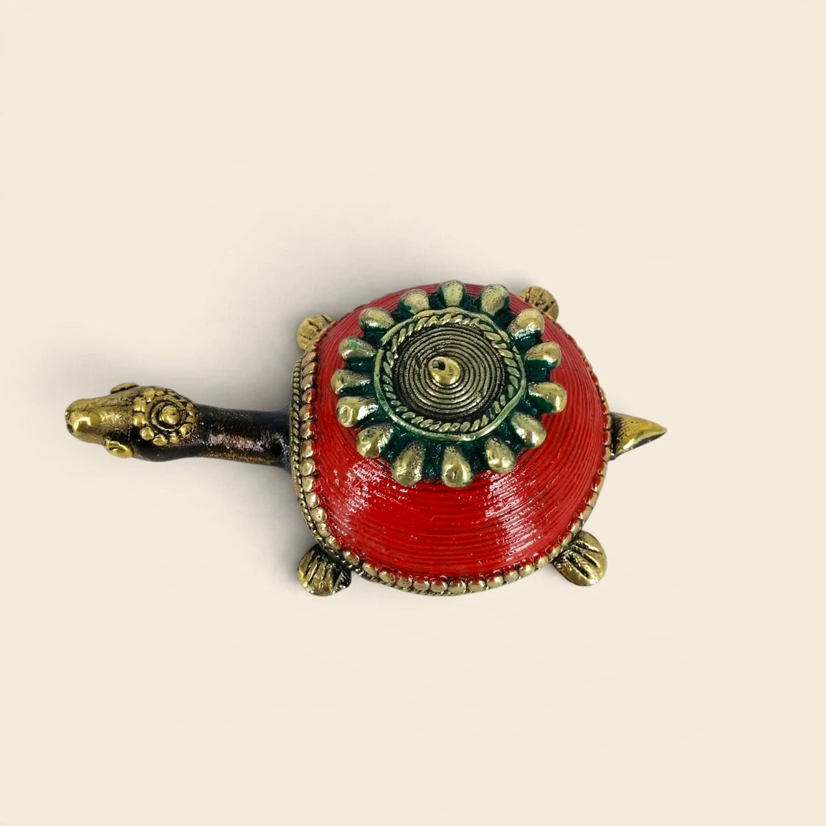 Top view of brass turtle trinket box showing detailed Dhokra lid with concentric rings and teardrop petals on red shell