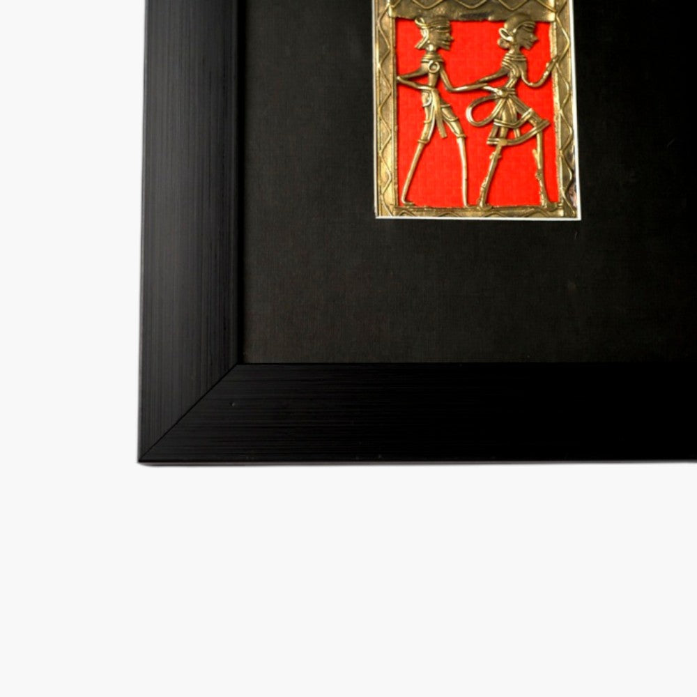 Handmade Bastar Dokra art brass figurine wall frame with dancing figures on red background and black wooden frame