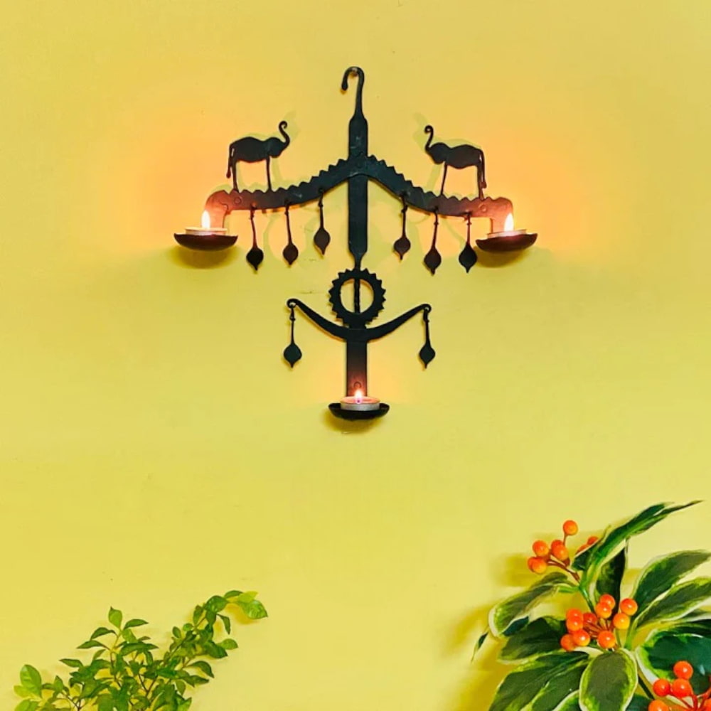 Handmade Bastar iron art elephant design wall hanging with lit diyas, styled as cultural wall decor for home