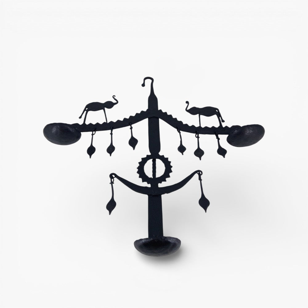 Studio front view of handmade Bastar iron art elephant wall hanging used as decorative wall diya