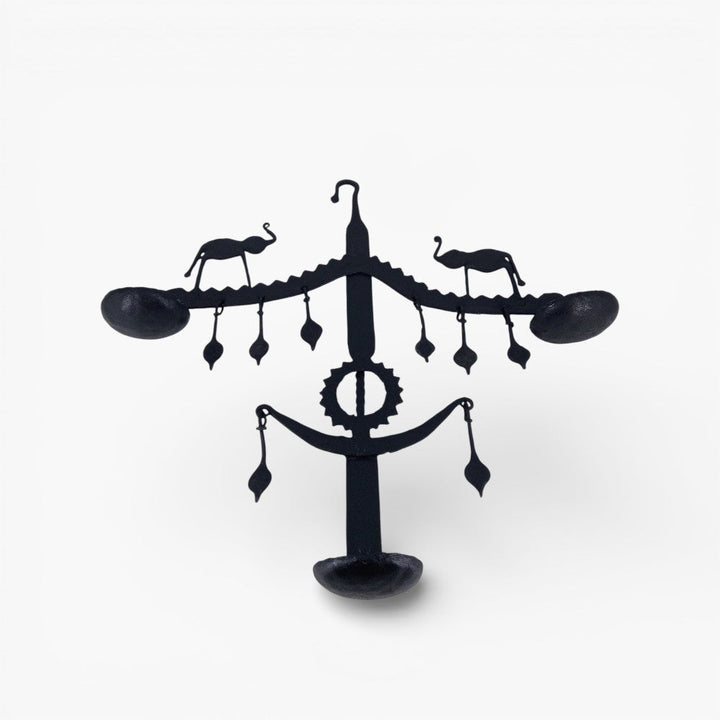 Studio front view of handmade Bastar iron art elephant wall hanging used as decorative wall diya