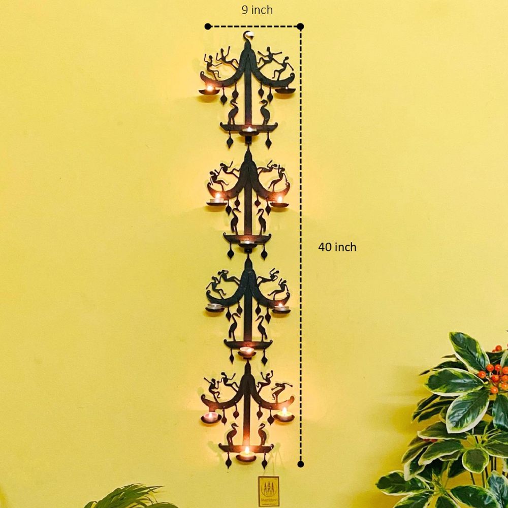 Handcrafted Bastar iron art moustache design wall hanging with tea light holders shown from the front with dimensions, highlighting vertical form, symmetrical iron detailing, and illuminated diyas