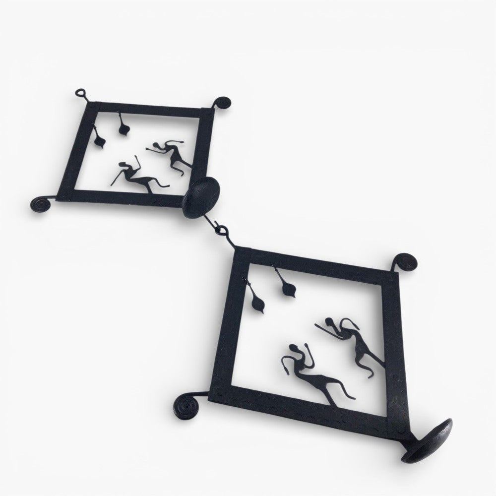 Bastar iron craft handmade square tile tea light wall hanging shown in a studio setup, focusing on wrought iron texture, folk art silhouettes, and candle holder design