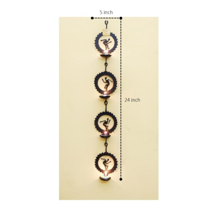 Handcrafted Bastar iron craft circle tea light wall hanging shown from the front with dimensions, highlighting detachable round panels, folk art silhouettes, and candle holder design