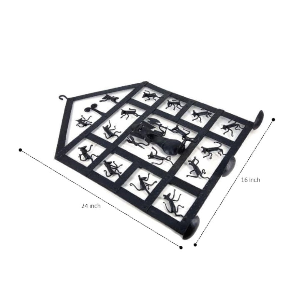 Handcrafted Bastar iron craft Ganesha wall hanging photographed from an angled top view, highlighting diya holders, mouse motifs, and solid wrought iron structure