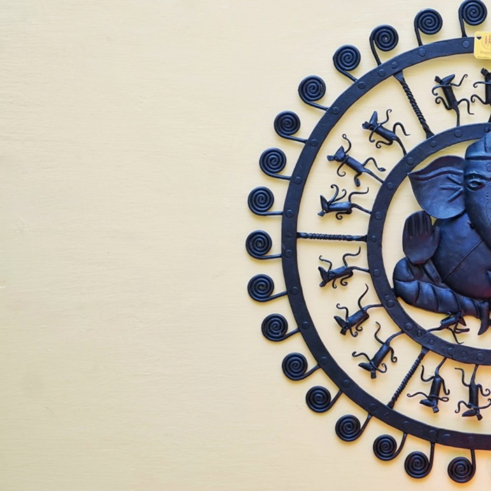 Bastar iron craft Ganesha wall decor shown in a close side composition highlighting spiral motifs and handcrafted iron figure