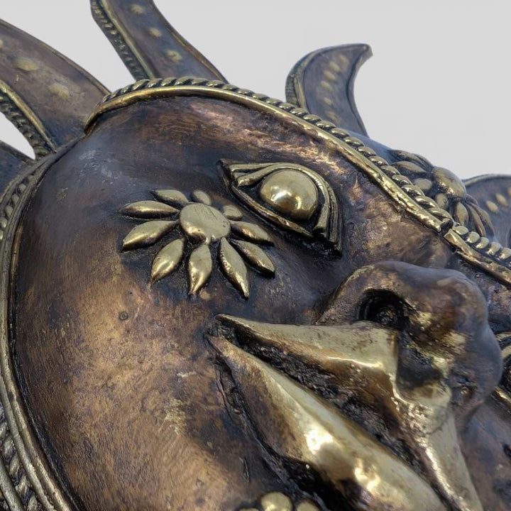 Close-up texture of Bastar Dokra art brass sun wall hanging