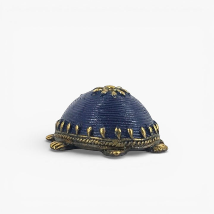 Front view of handcrafted bell metal turtle figurine in blue finish highlighting sculpted head and antique brass detailing