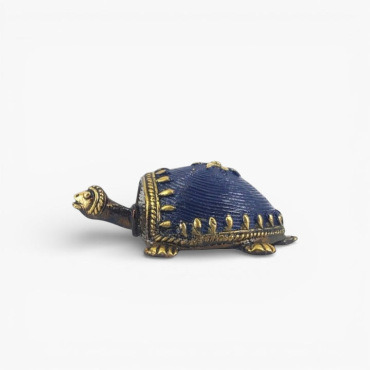 Side profile of handmade Dhokra bell metal turtle figurine showcasing curved shell texture and fine artisan detailing