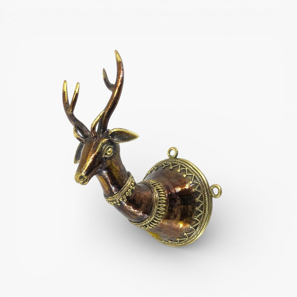 Handcrafted bell metal Dhokra decorated deer head wall hanging photographed from an angled front view showcasing bronze finish and detailed metal patterns