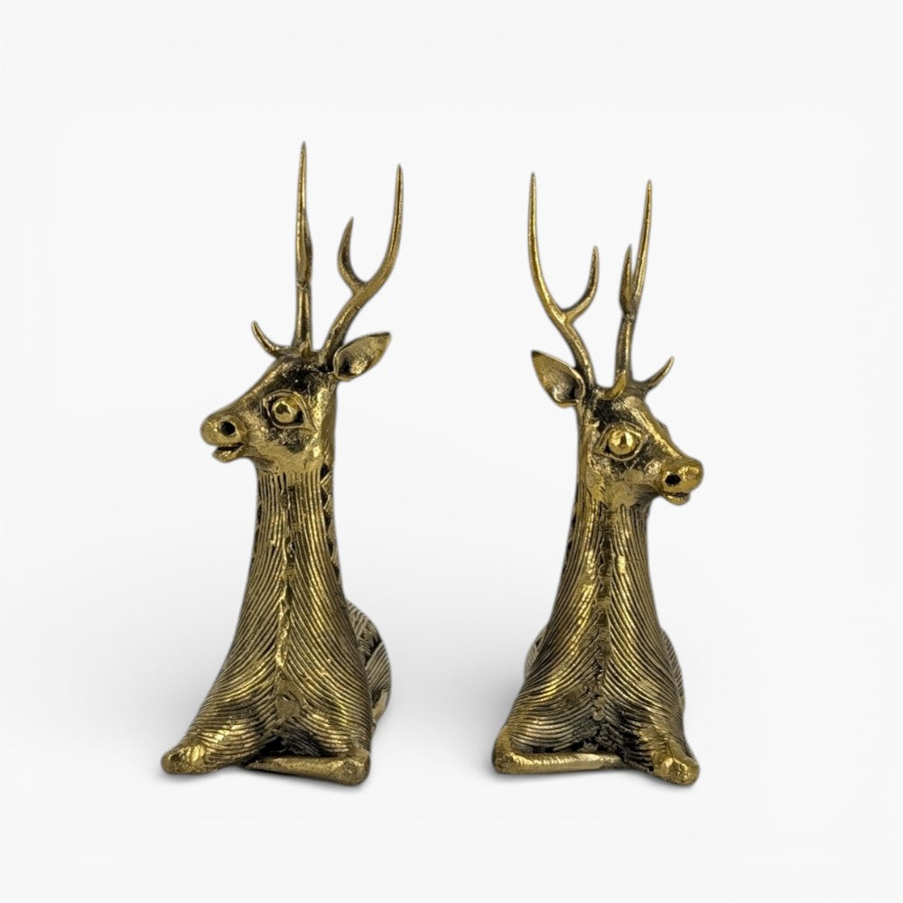 Angled studio view of brass bell metal sitting deer pair showcasing intricate Dhokra craftsmanship
