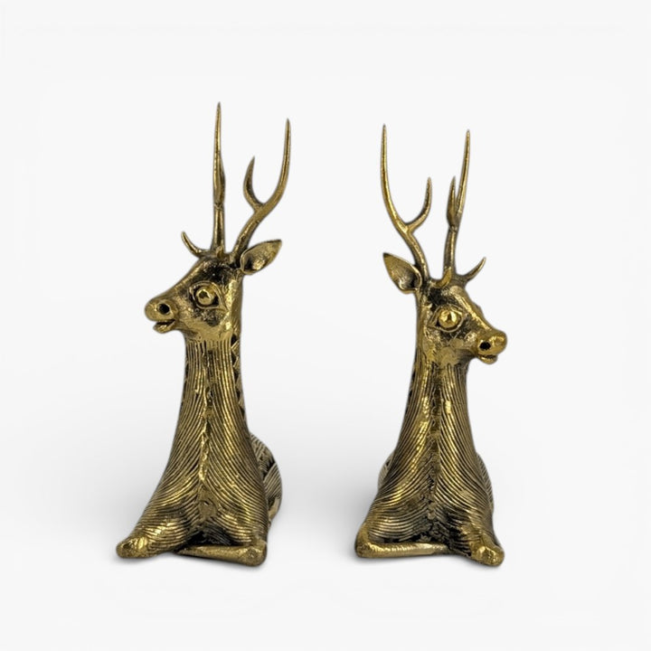 Angled studio view of brass bell metal sitting deer pair showcasing intricate Dhokra craftsmanship
