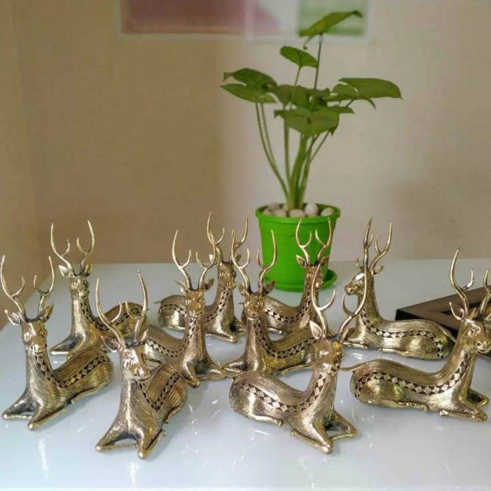 Group display of handcrafted brass bell metal sitting deer figurines arranged for decor and gifting