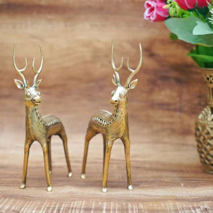Handcrafted Dhokra art brass deer duo standing on a wooden surface as elegant home decor showpieces