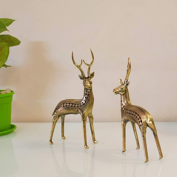Handcrafted Dhokra art brass deer duo standing on a wooden surface as elegant home decor showpieces