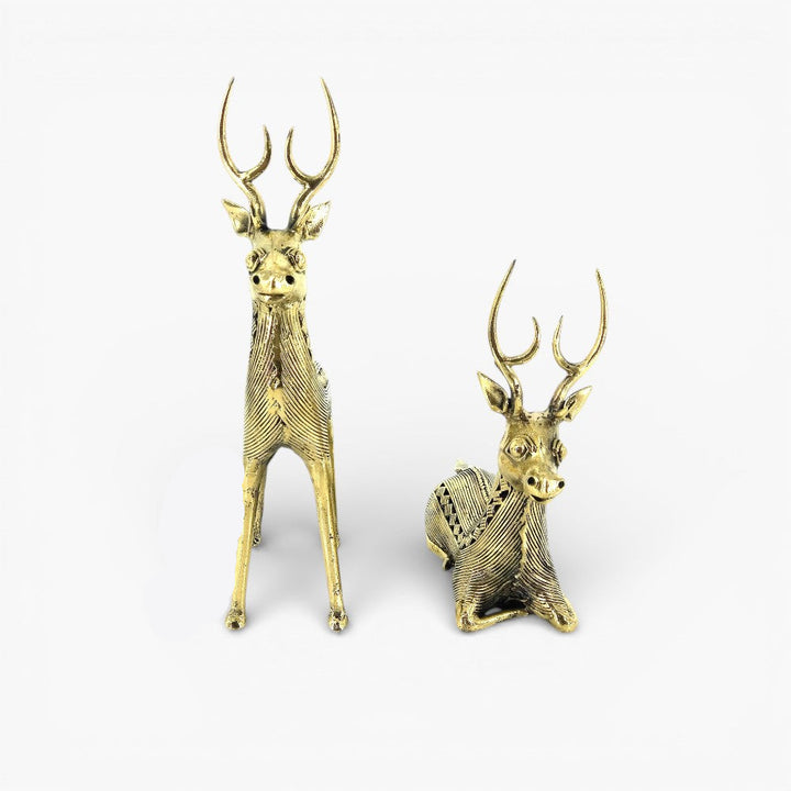 Angled view of brass deer statues showing standing and sitting forms crafted in traditional Bastar Dokra art