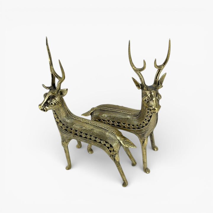 Angled studio view of handcrafted brass deer standing pair showcasing detailed antlers and body texture