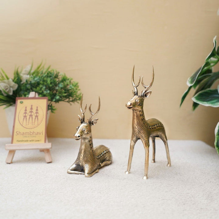Golden brass deer statues handcrafted in Dokra art style displayed with indoor plants for living room decor styling