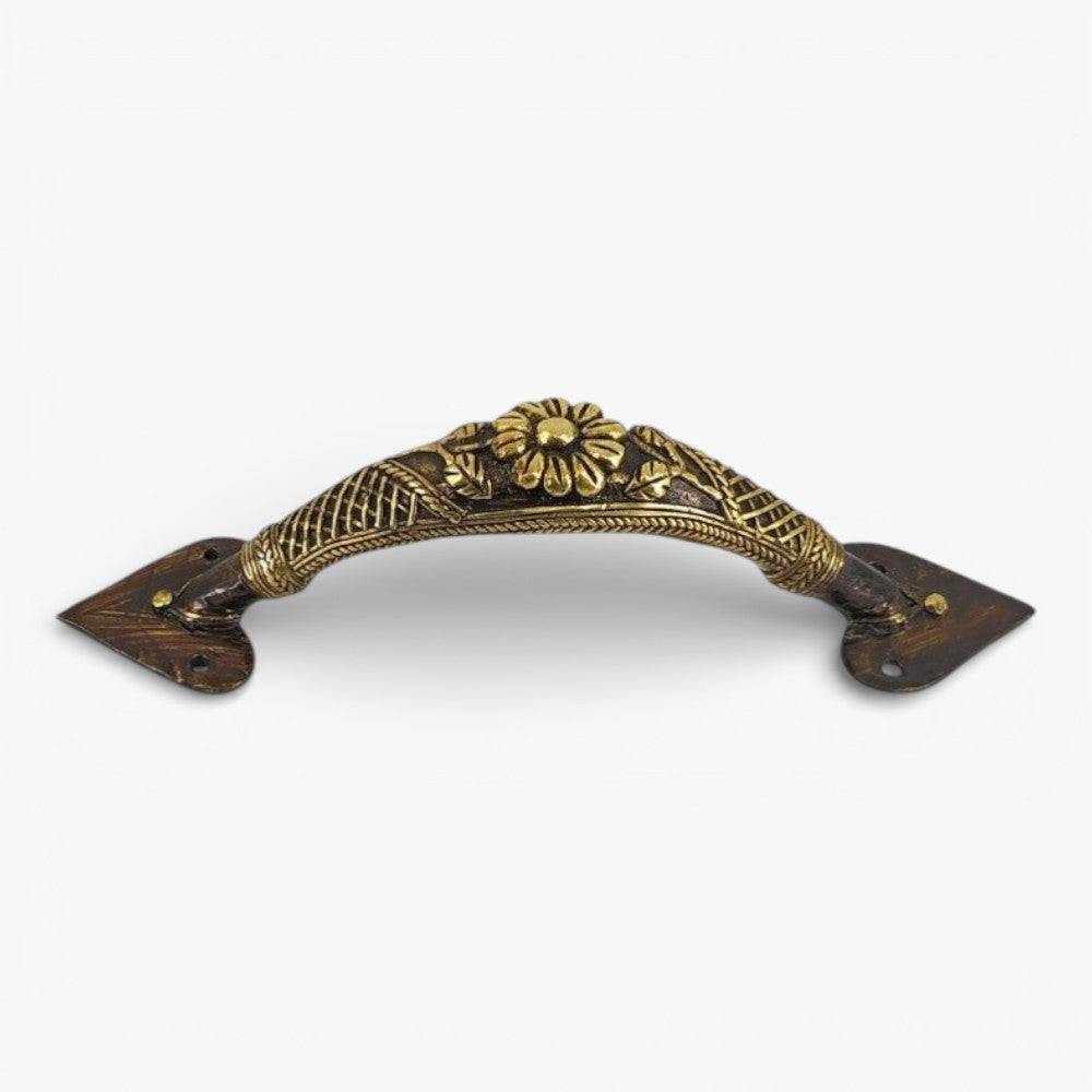 Studio view of bronze finish brass door handle with floral centerpiece and traditional lattice craftsmanship
