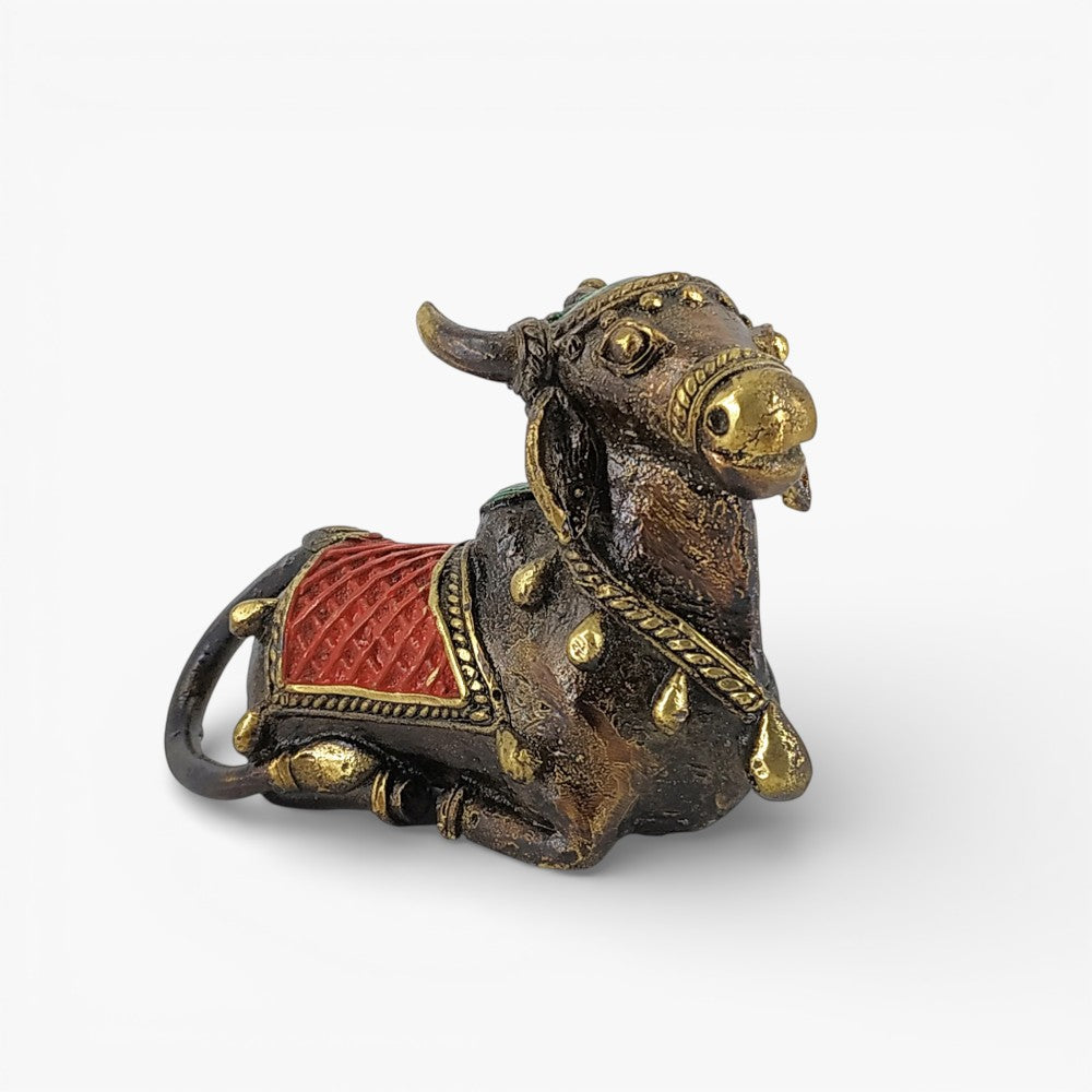 Close-up of brass Nandi with red  detailing