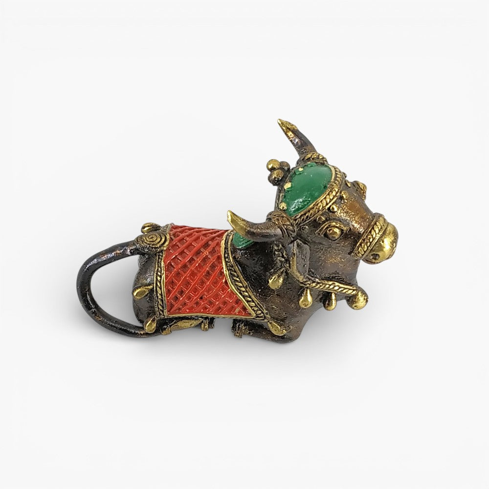 Close-up of brass Nandi with red green detailing