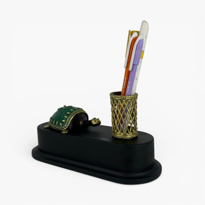 Decorative brass turtle desk organizer with green shell and metal lattice pen holder on wooden base