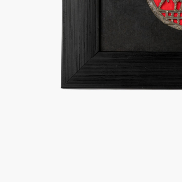 Close-up of black wooden frame corner from Circles of Celebration brass wall frame in Bastar Dokra art, 18 inch black and red decor