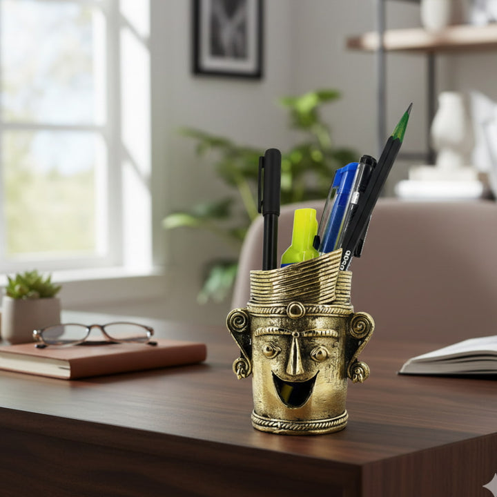 Crowned Smile Bastar Dokra art brass pen holder with expressive face design, golden finish handcrafted desk accent for office or study, 3.5 inch