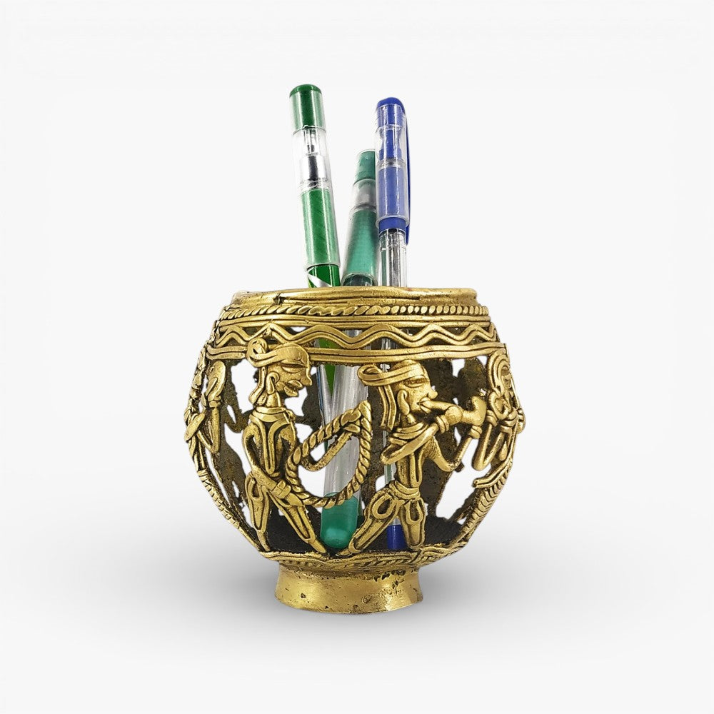 Front view of Dhokra art brass pen holder featuring marching tribal musicians with detailed handcrafted metal work