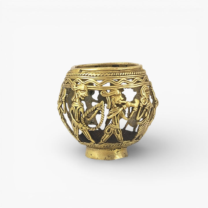 Studio front view of handcrafted brass pen holder showcasing Dhokra art marching musicians all aaround