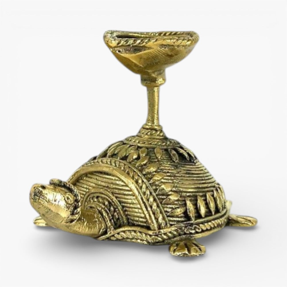 Front side view of handcrafted bell metal tortoise diya highlighting Bastar Dhokra art detailing