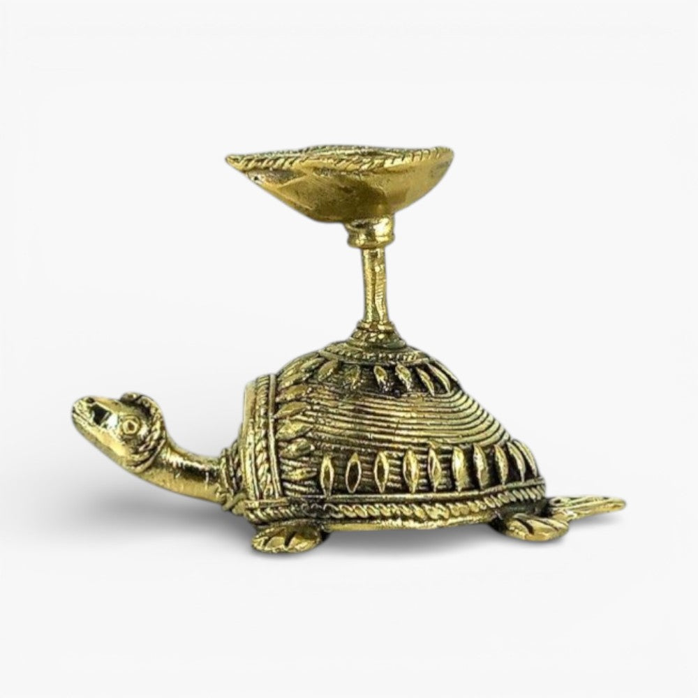 Left side view of Dhokra art bell metal tortoise diya showing textured shell design and raised diya cup