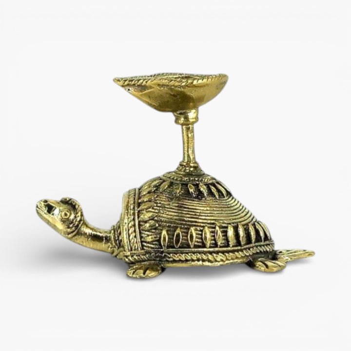 Left side view of Dhokra art bell metal tortoise diya showing textured shell design and raised diya cup