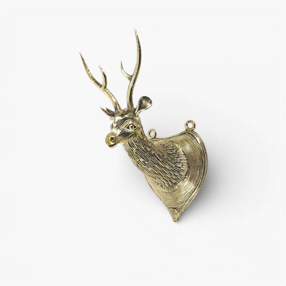Brass Bastar Dokra deer head wall art photographed from an angled side view highlighting the textured metal detailing