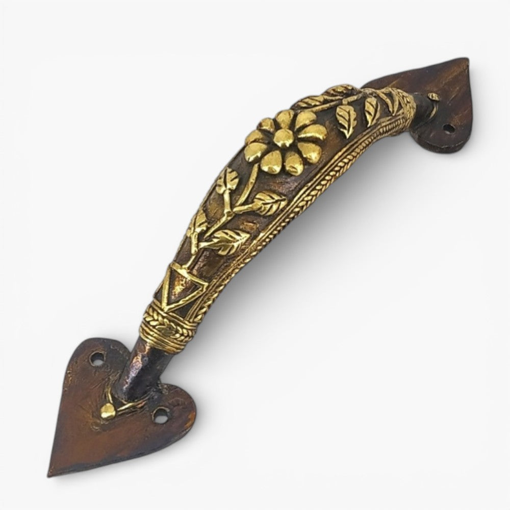 Handcrafted Dhokra bell metal door handle with flower and leaf design in bronze finish showing ornate curved detailing