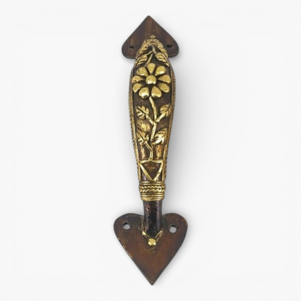 Front view of Dhokra art bell metal door handle featuring floral centerpiece and traditional leaf carving