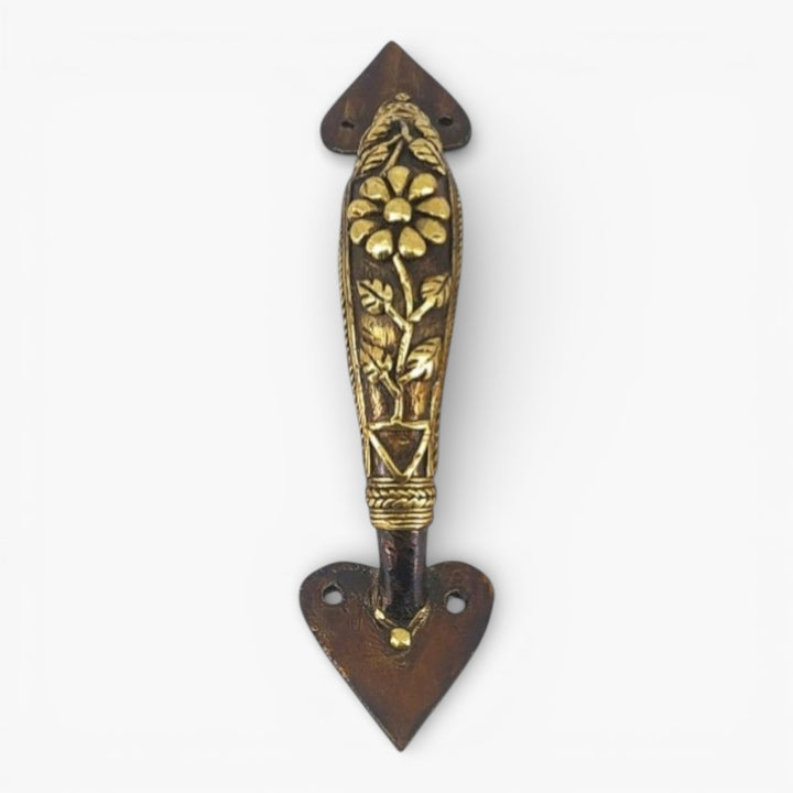 Front view of Dhokra art bell metal door handle featuring floral centerpiece and traditional leaf carving
