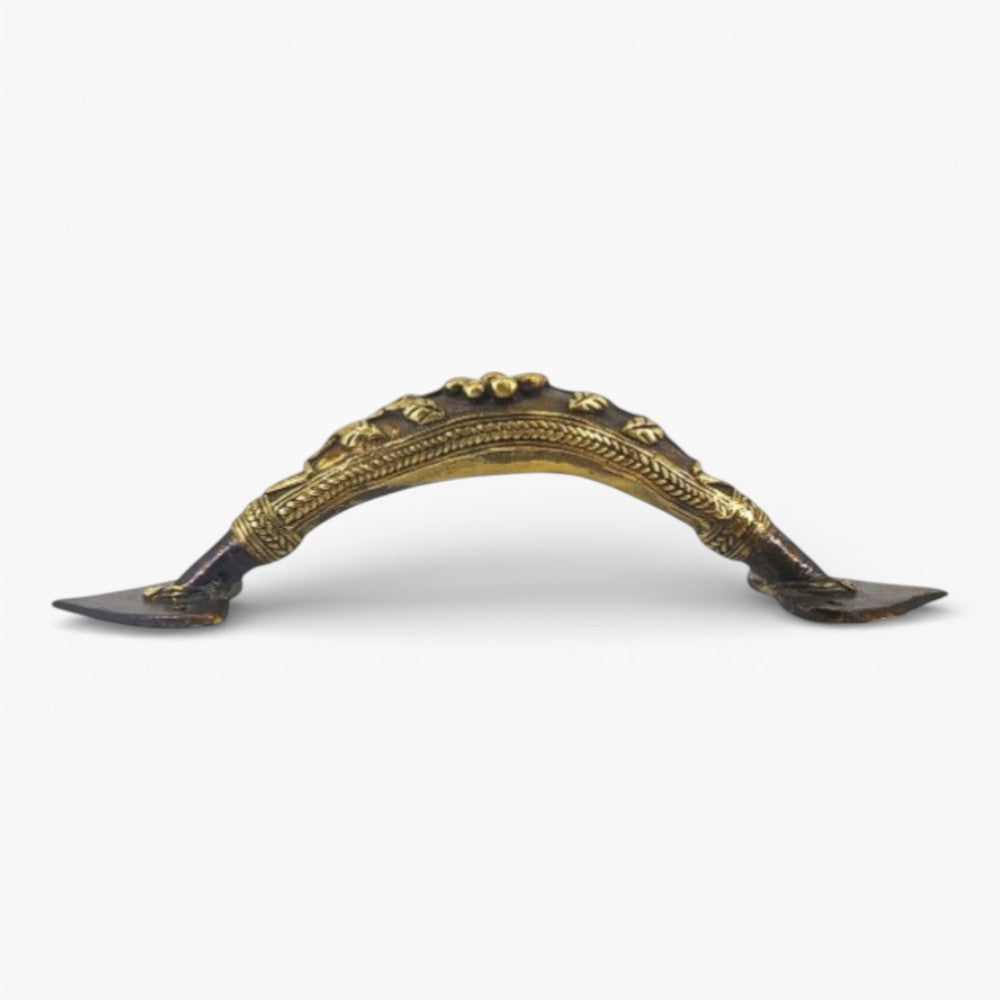 Side profile of handcrafted bell metal door handle highlighting curved grip and intricate Dhokra metalwork