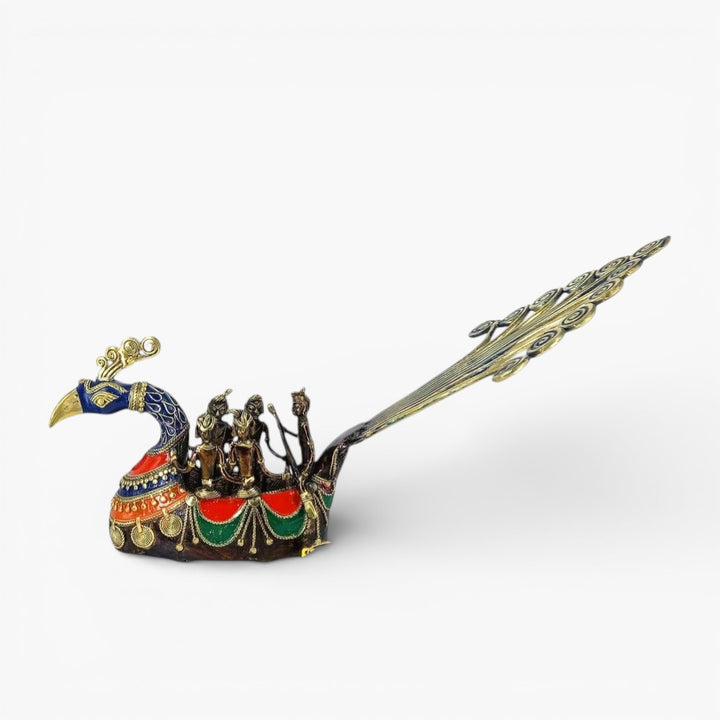 Side profile of Bastar Dhokra art brass peacock boat statue showcasing elongated tail form and detailed multicolor metal work
