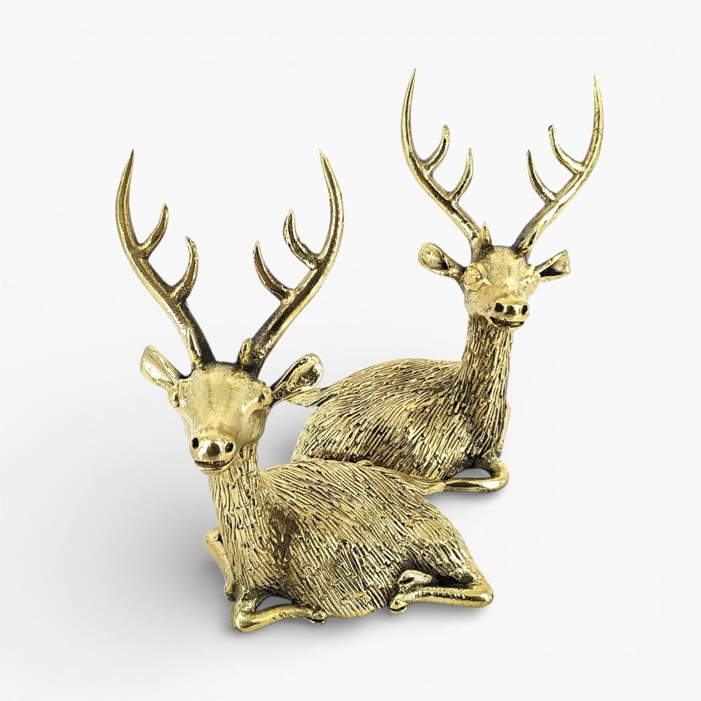 Handcrafted brass deer pair with antlers resting pose front view