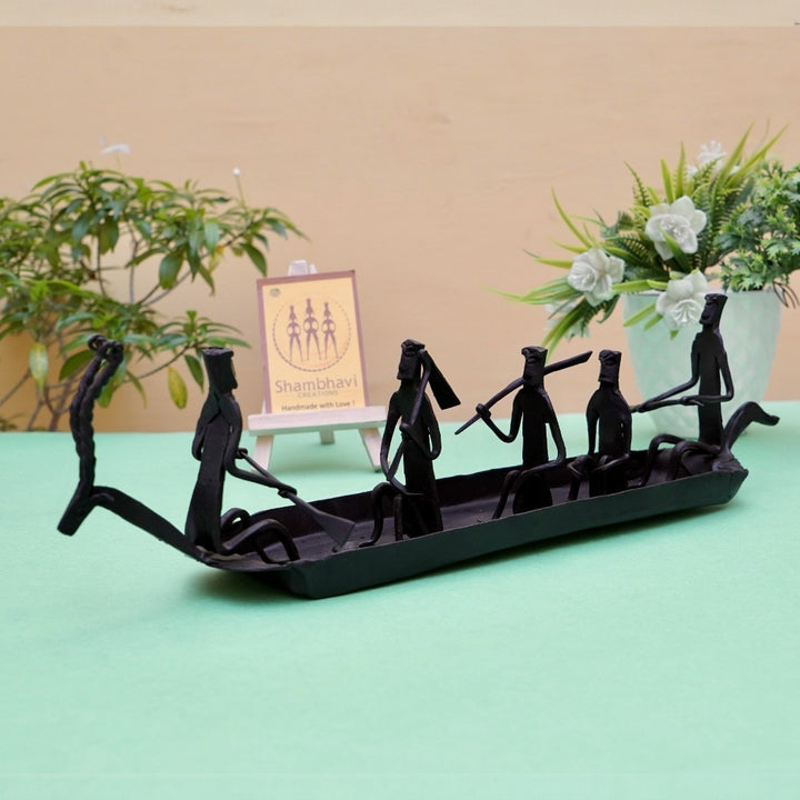 Handcrafted Bastar iron art Kerala boat tabletop showpiece in black finish displayed in a lifestyle setting highlighting tribal craftsmanship