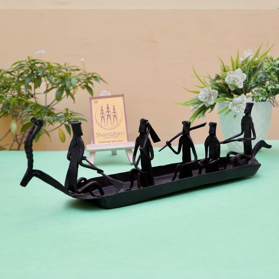 Handcrafted Bastar iron art Kerala boat tabletop showpiece in black finish displayed in a lifestyle setting highlighting trib