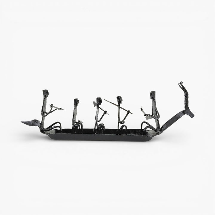 Side profile of handcrafted Bastar tribal iron Kerala boat showpiece showcasing riveted construction and artisan figure detailing