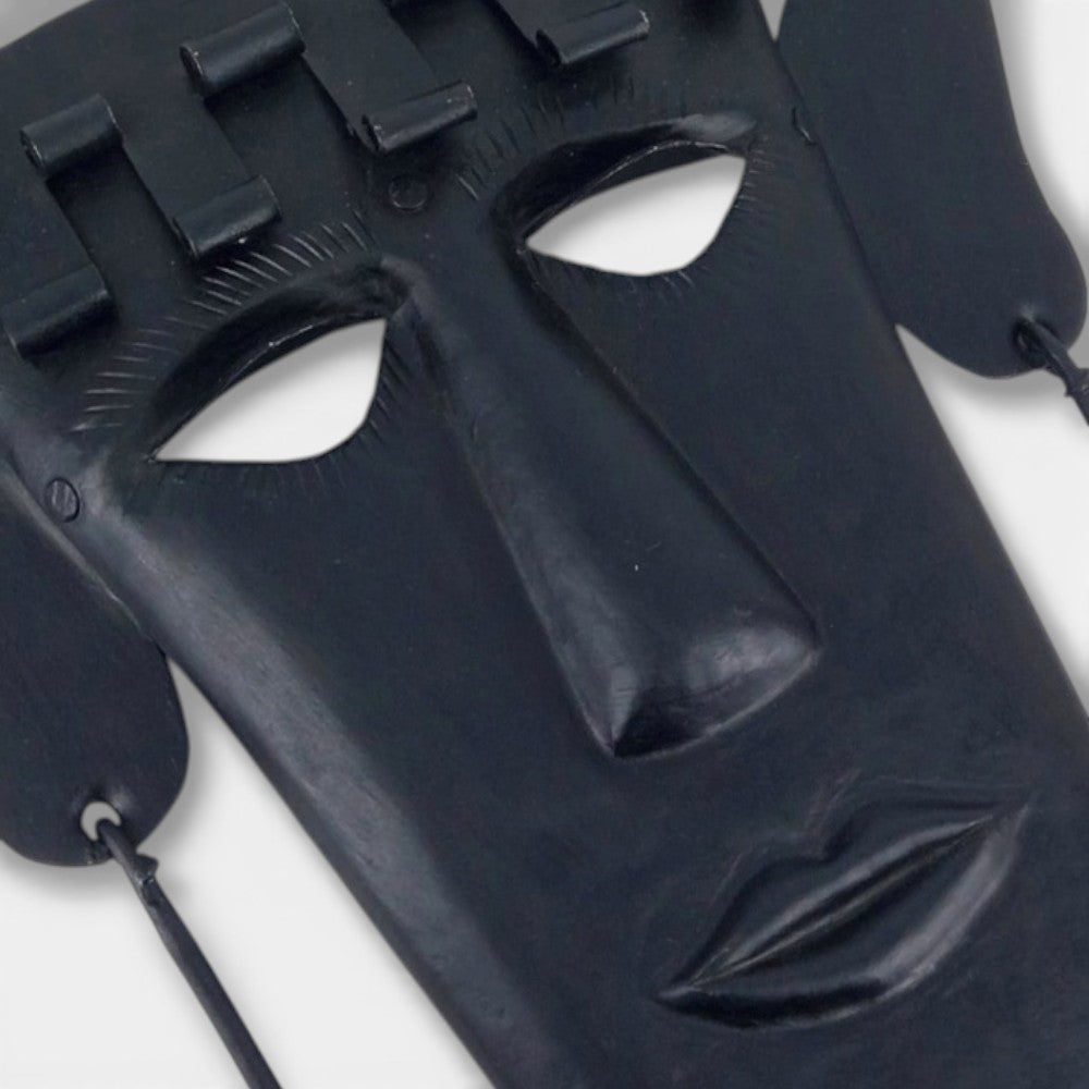 Close up view of Madia tribal Bastar iron wall mask highlighting facial contours, matte black finish, and hand-hammered detai