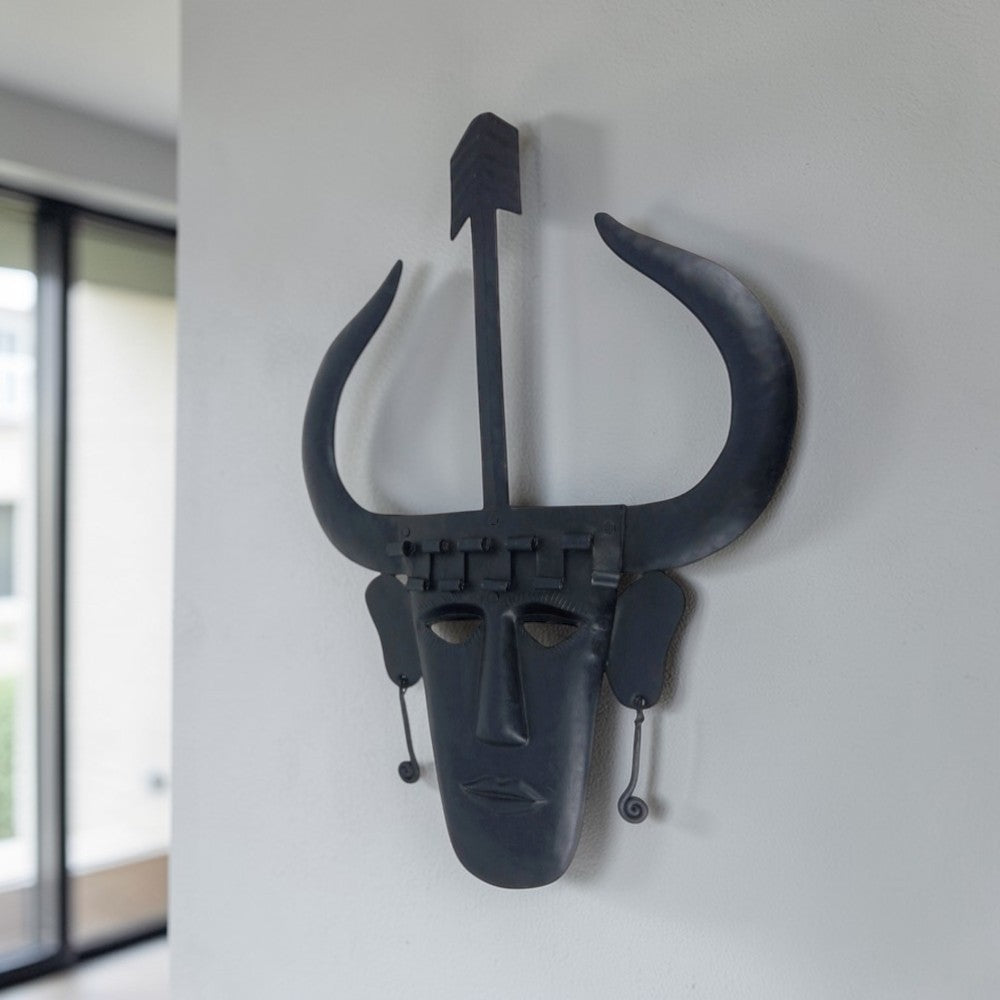 Handmade Madia tribal Bastar iron wall mask in black matte finish displayed on wall in a lifestyle setting for home decor
