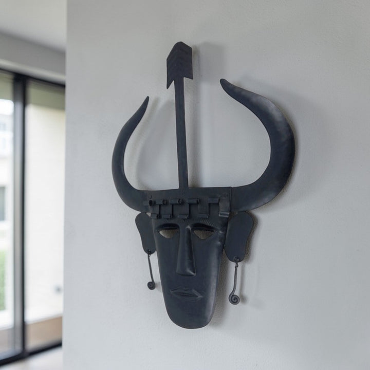 Handmade Madia tribal Bastar iron wall mask in black matte finish displayed on wall in a lifestyle setting for home decor